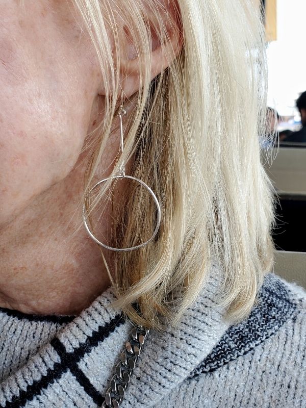 long silver stick hoop earrings on ear